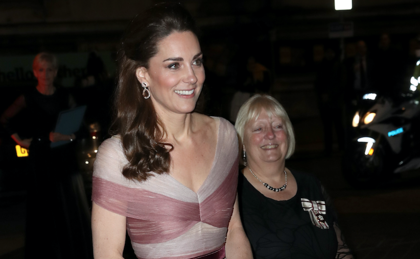 Kate Middleton smiling in a pink gown while out in London