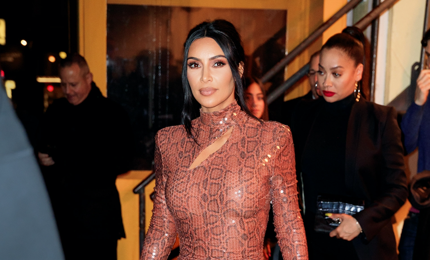 Kim Kardashian walking in NYC wearing a skintight, snakeskin dress