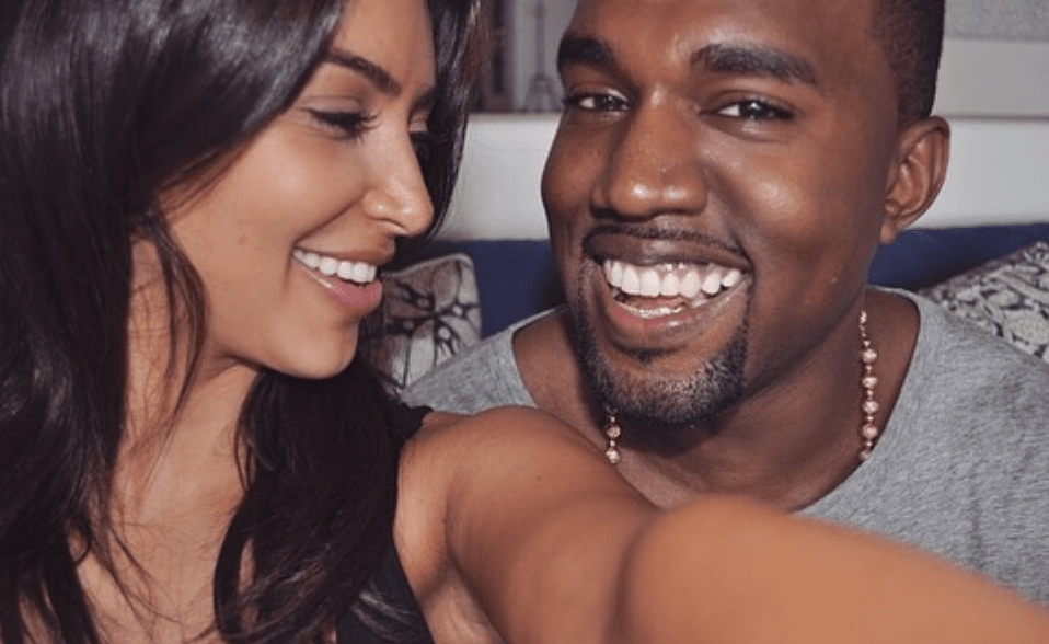 Kim Kardashian and Kanye West taking a selfie smiling