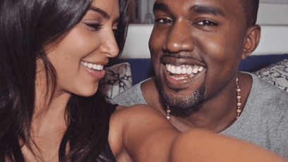 Kim Kardashian and Kanye West taking a selfie smiling