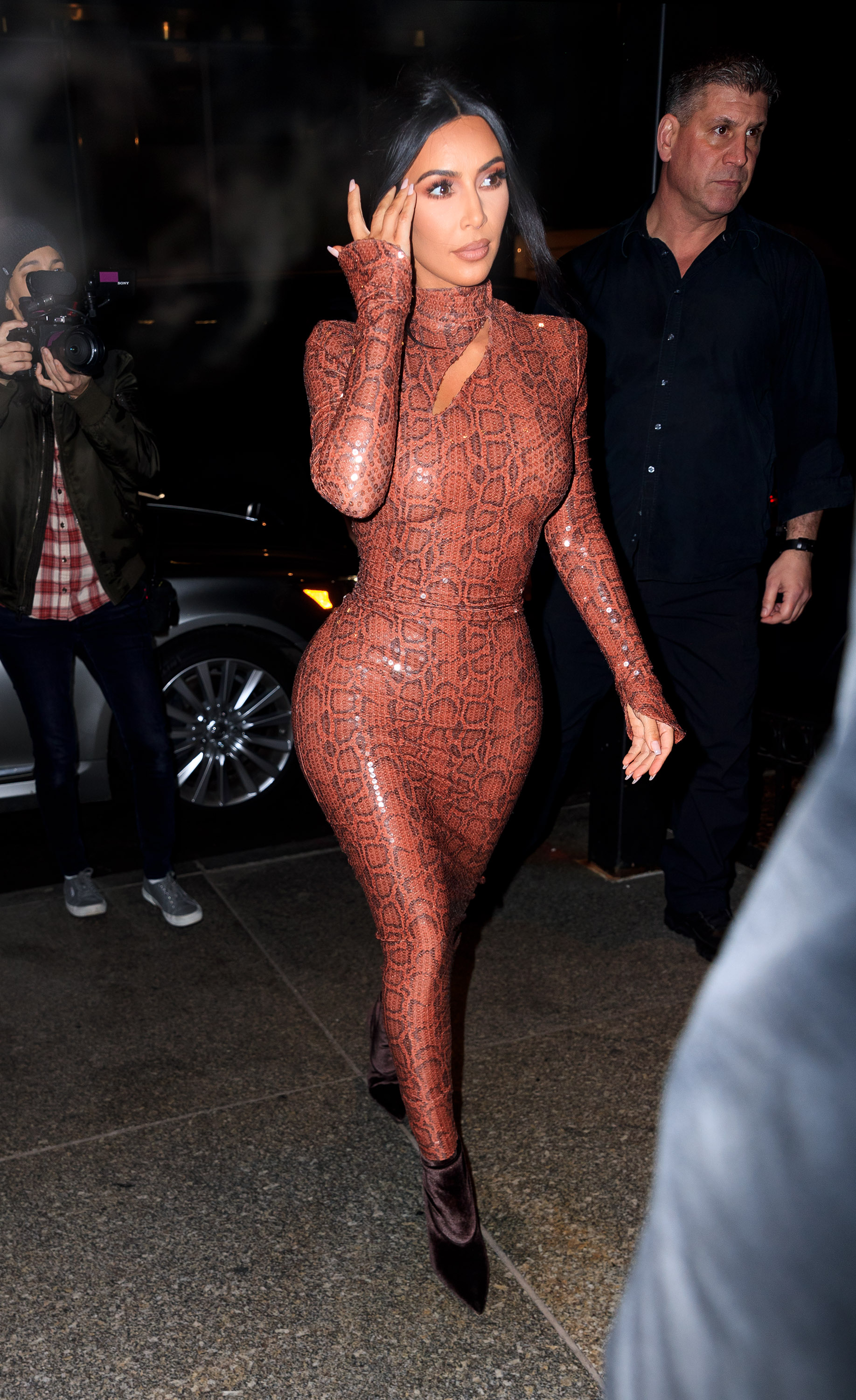 Kim Kardashian walking in NYC wearing a skintight, snakeskin dress