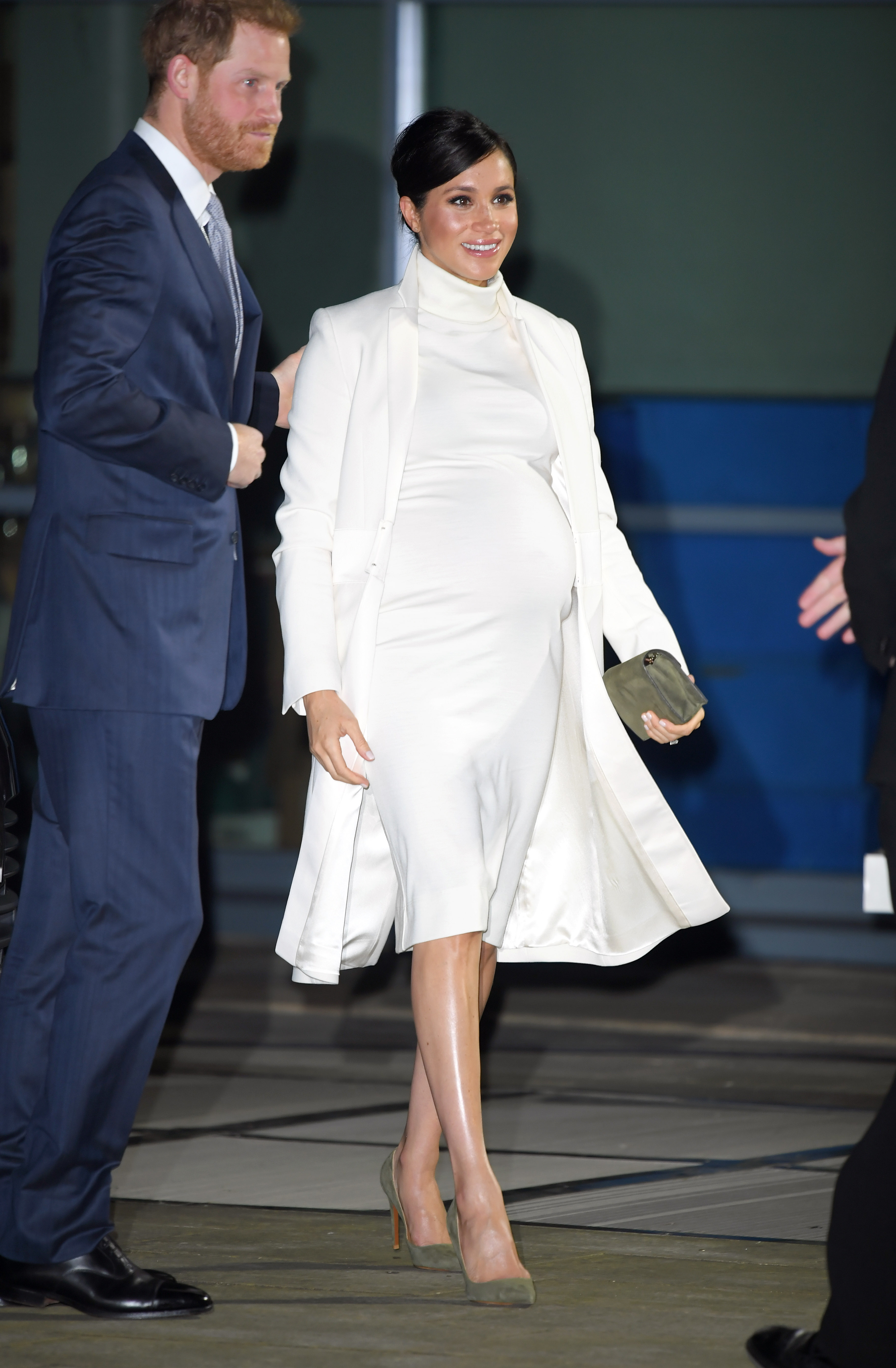 Meghan Markle in a white dress with Prince Harry in a navy suit