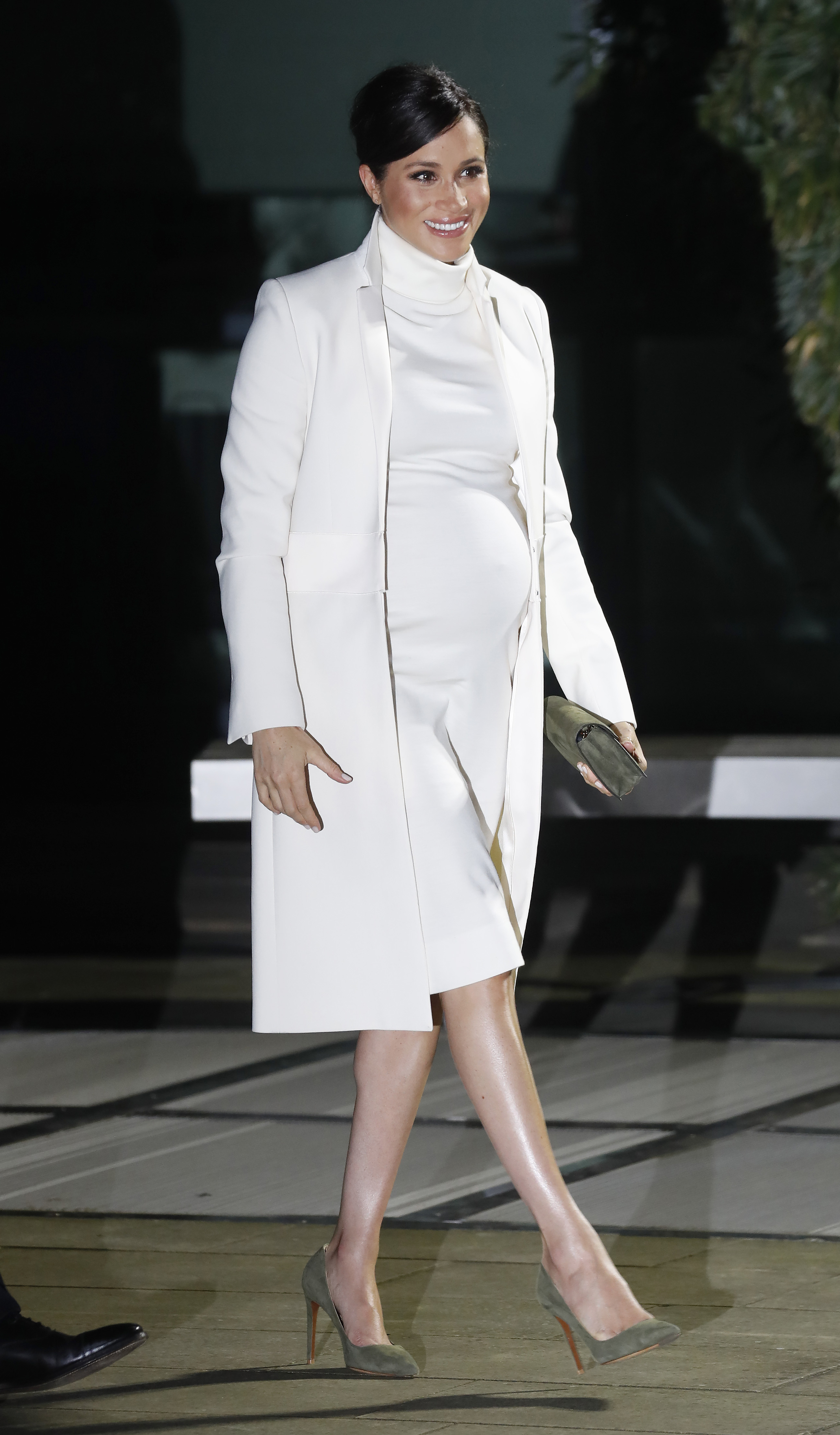 Meghan Markle in a white dress with Prince Harry in a navy suit