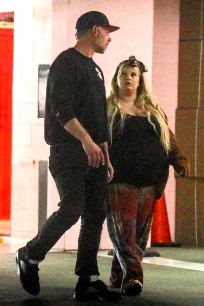 A very pregnant Jessica Simpson walking with her husband Eric Johnson