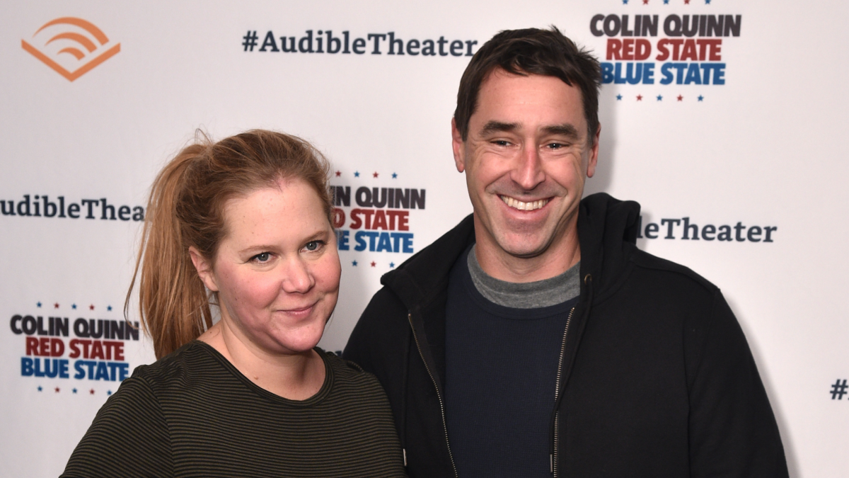 Amy Schumer posing with husband Chris Fischer.