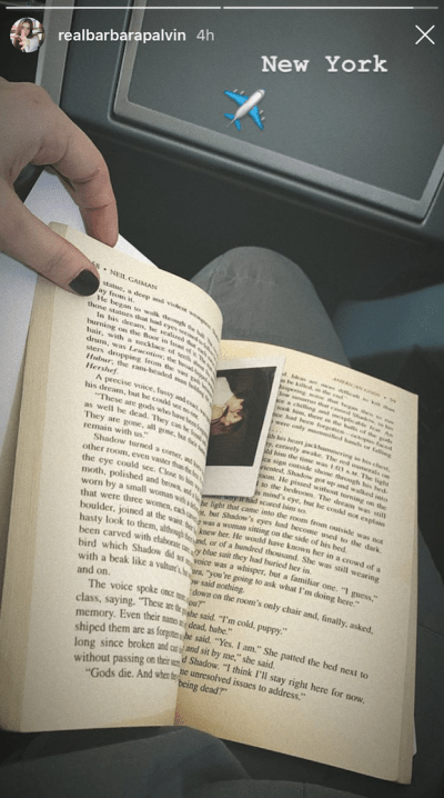 A picture of Neil Gaiman's American Gods with a Polaroid bookmark.