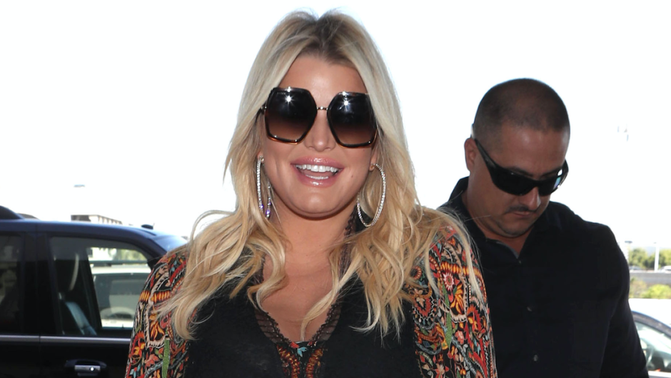 Jessica Simpson smiling and wearing black sunglasses.