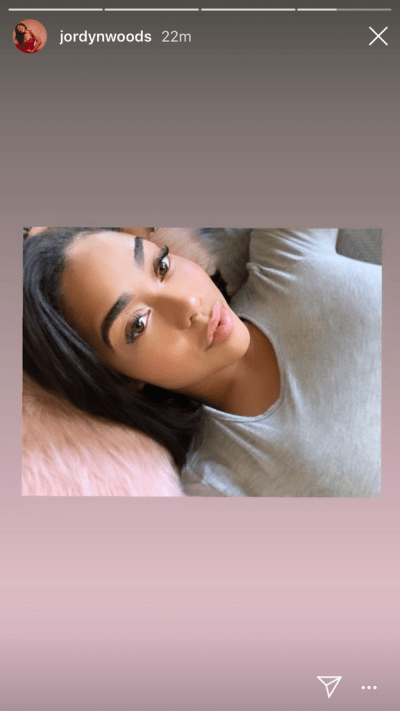 Jordyn Woods taking a selfie in bed.
