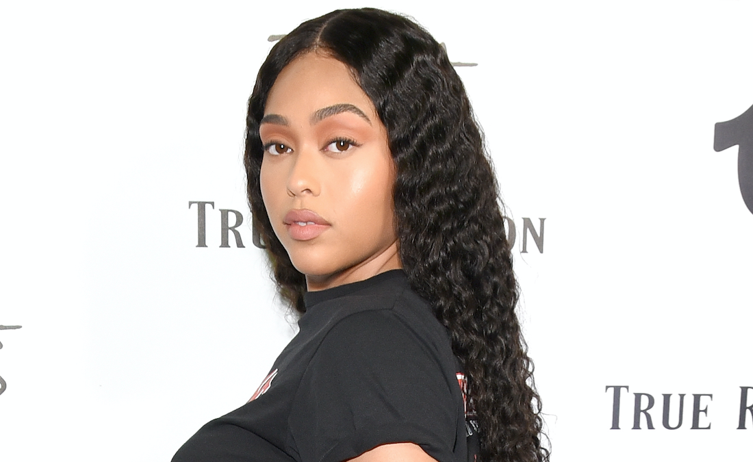 Jordyn Woods posing in a black t-shirt.