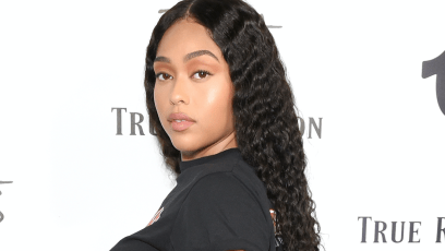 Jordyn Woods posing in a black t-shirt.