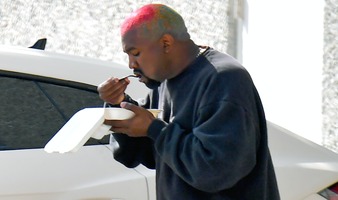 Kanye West eating lunch outside