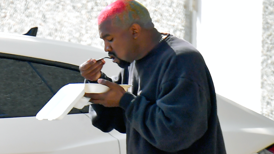Kanye West eating lunch outside