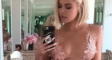 Khloe Kardashian takes a mirror selfie in a nude colored bra.