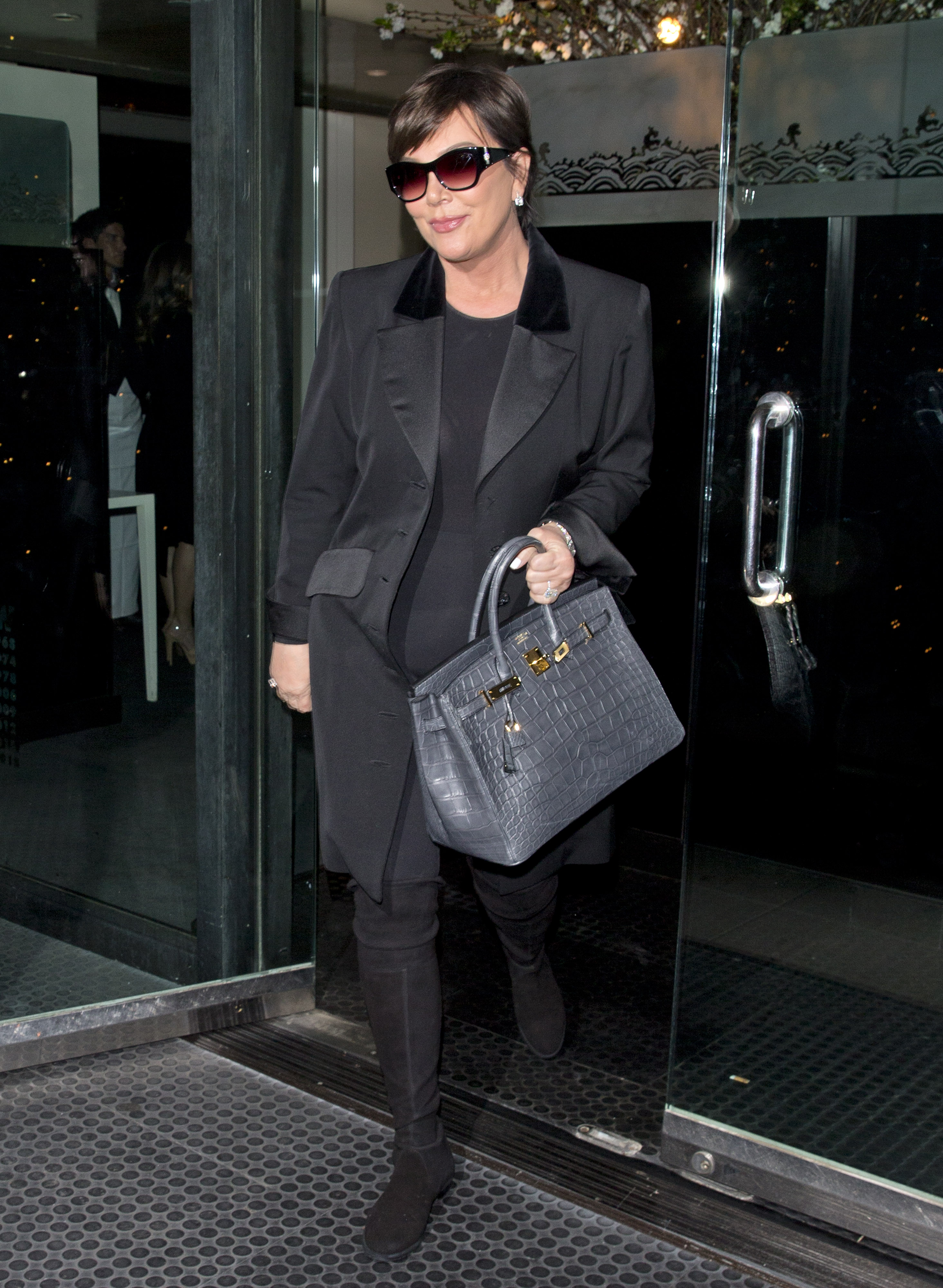 Kris Jenner walking in Beverley Hills wearing an all black outfit.