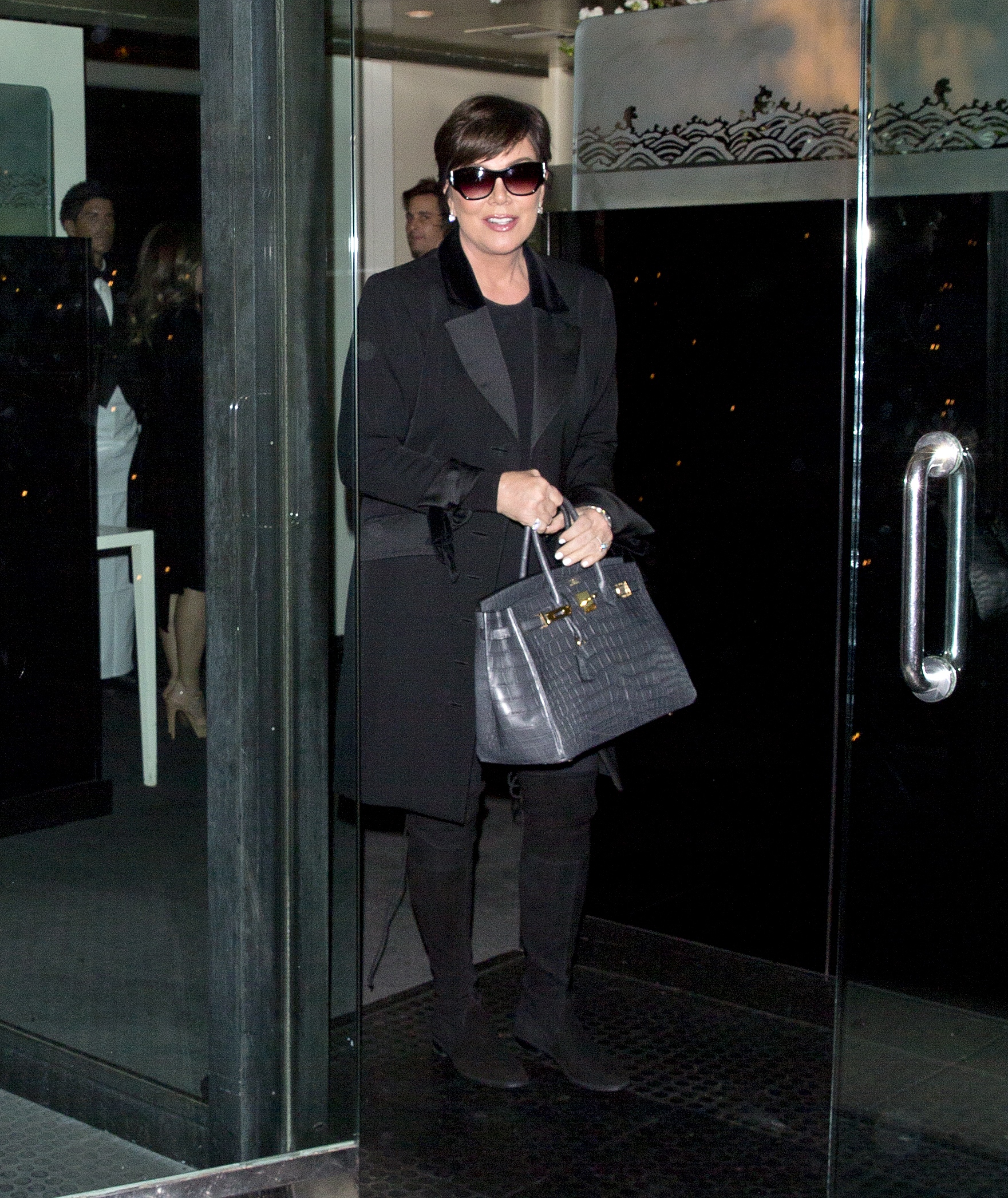 Kris Jenner walking in Beverley Hills wearing an all black outfit.