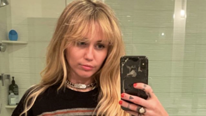 Miley Cyrus taking a mirror selfie as Hannah Montana.
