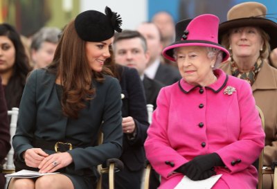 Queen Elizabeth II (R) and Catherine, Duchess of Cambridge (L) watch a fashion show at De Montfort University on March 8, 2012 in Leicester, England.