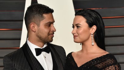 Wilmer Valderrama and Demi Lovato 2016 oscars black dress black tux red carpet