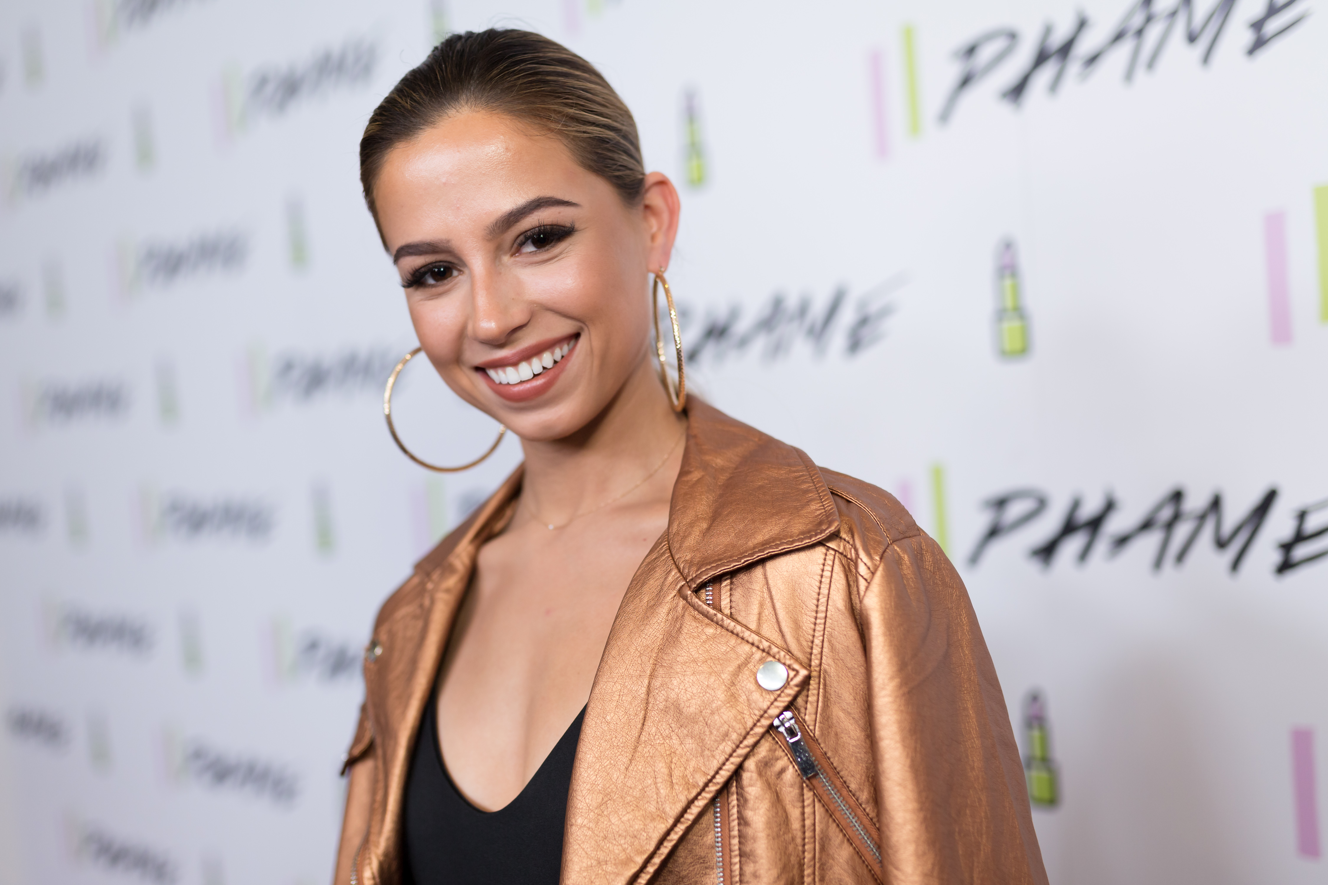 Kristina Schulman hair pulled back and gold hoops
