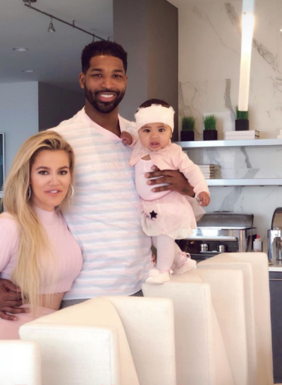 Khloe Kardashian posing with Tristan Thompson and baby True