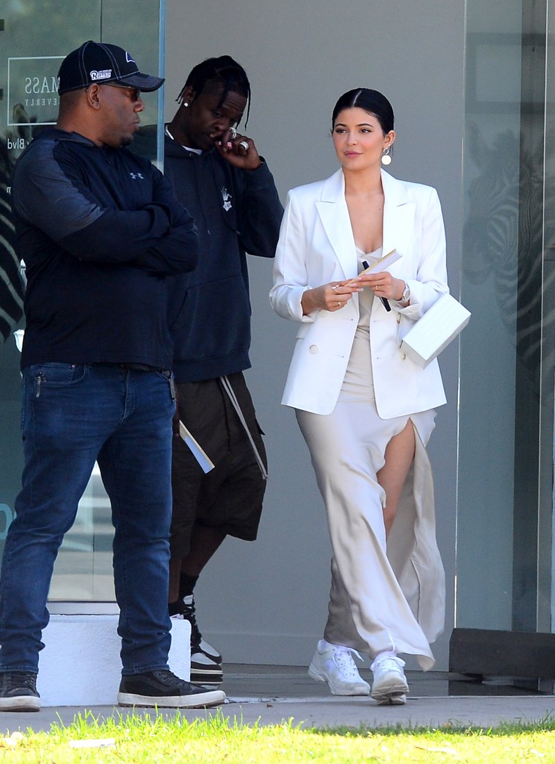 Kylie Jenner brown silk dress white coat Travis Scott