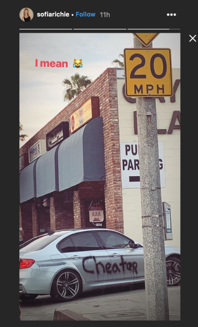 A picture of a car that says Cheater on it in black spray paint