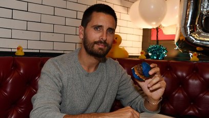 Scott Disick Eating a Burger Wearing a Gray Sweatshirt