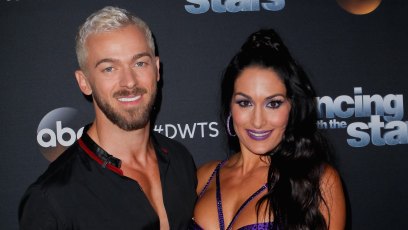 Artem Chigvintsev and Nikki Bella posing