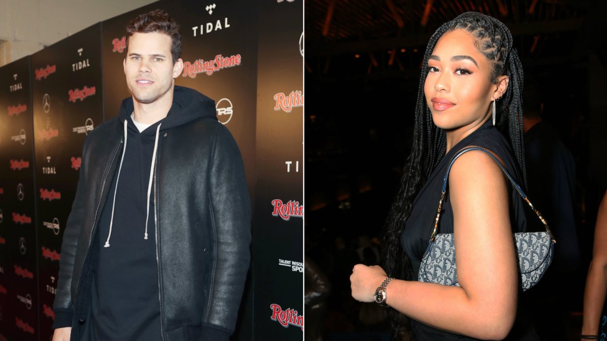 Kris Humphries in leather jacket and hoodie and Jordyn Woods wearing black dress and dior bag