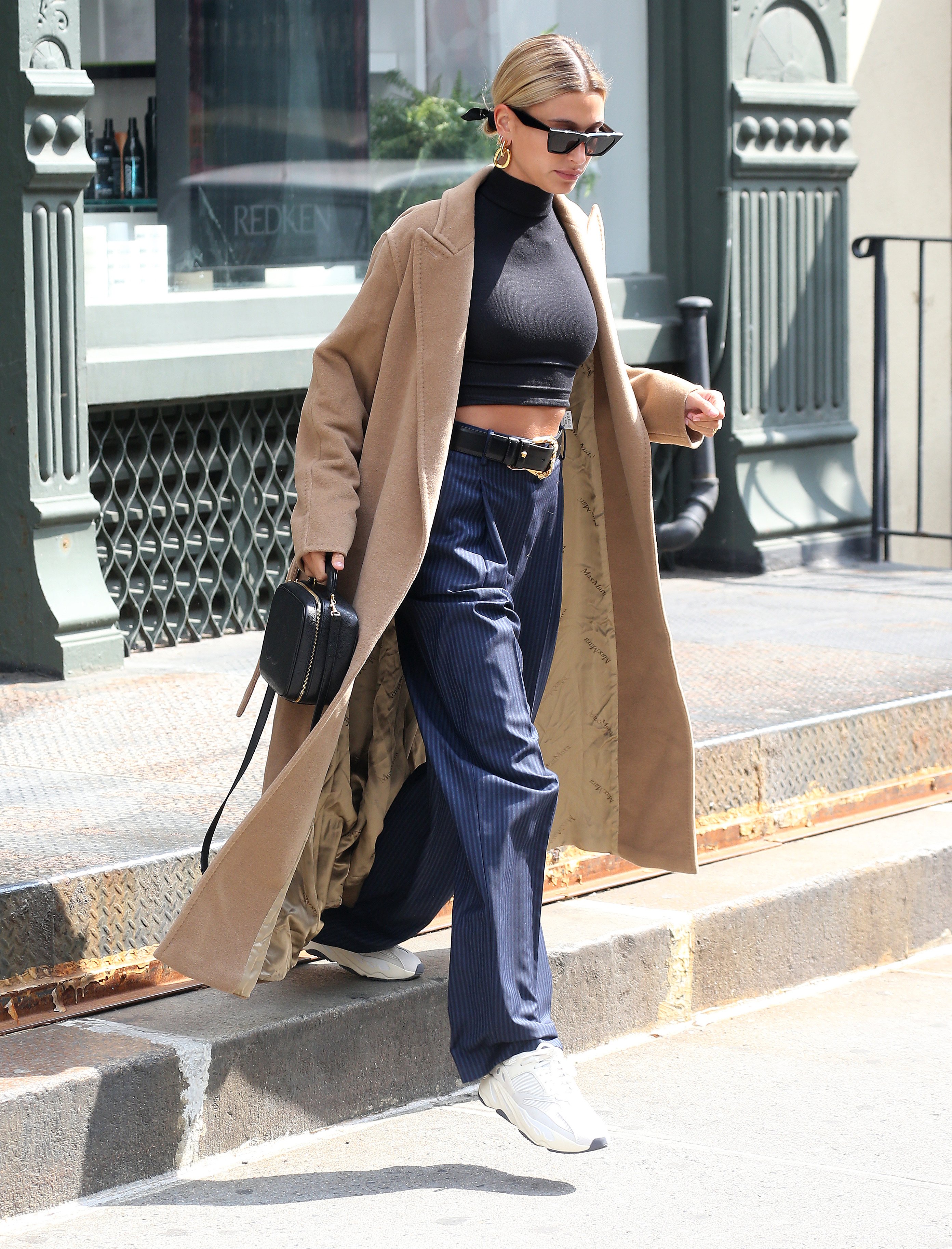 Hailey Baldwin long tan coat black crop top high waisted pants
