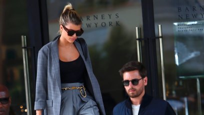 Sofia Richie blue grey suit high waisted pants gold chain belt black tank top ponytail sungalsses Scott Disick blue jacket grey tshirt blue jeans sunglasses