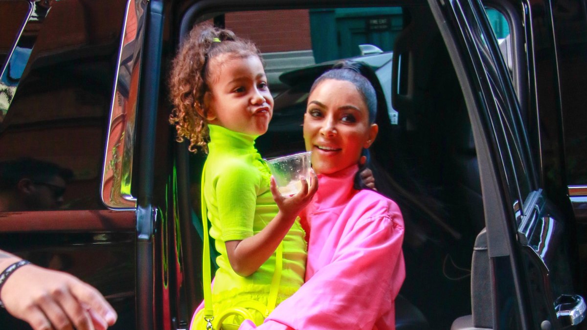 North West being carried by Kim Kardashian