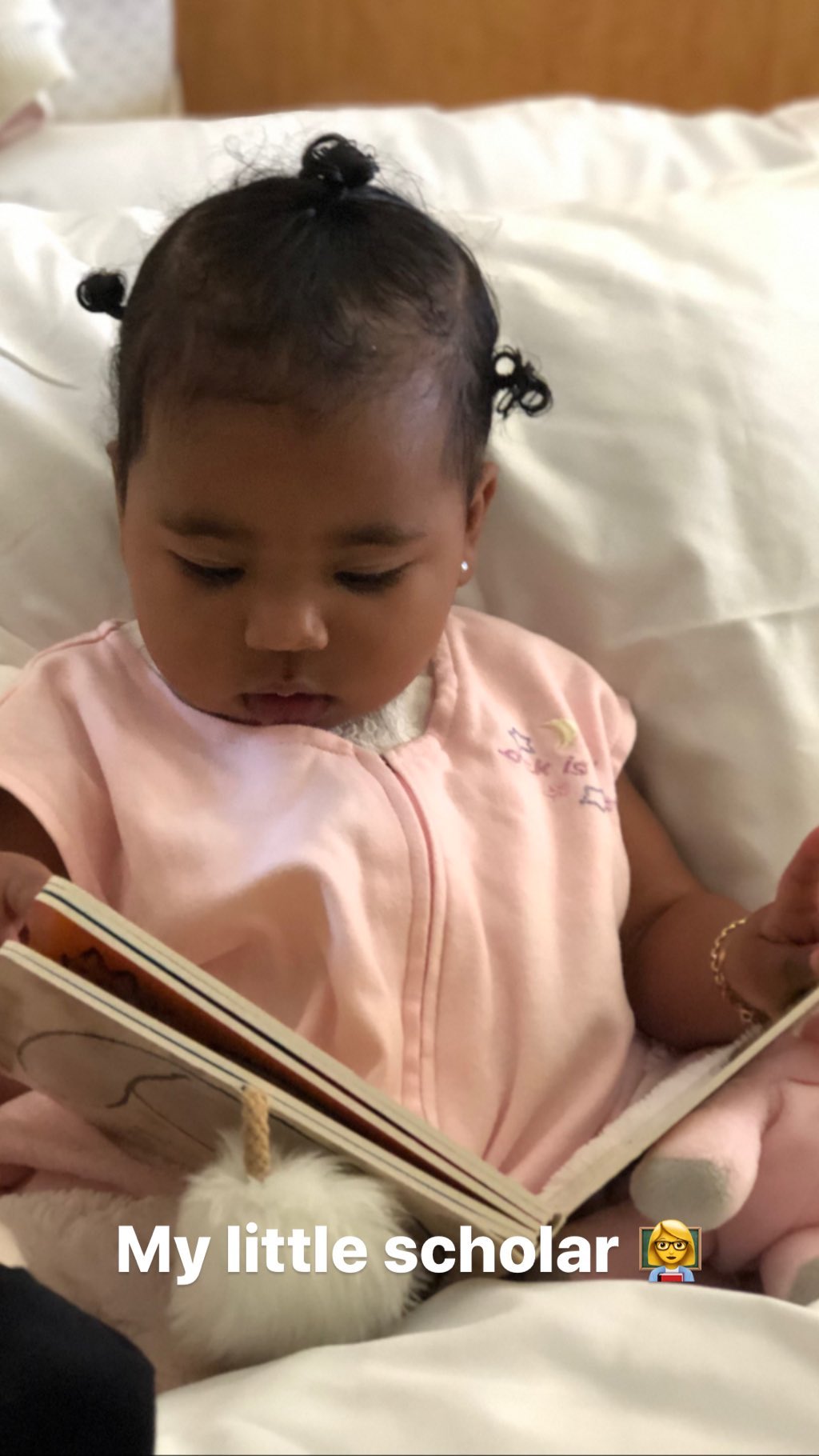 True Thompson reading pink onesie pigtails tristan thompson instagram khloe kardashian