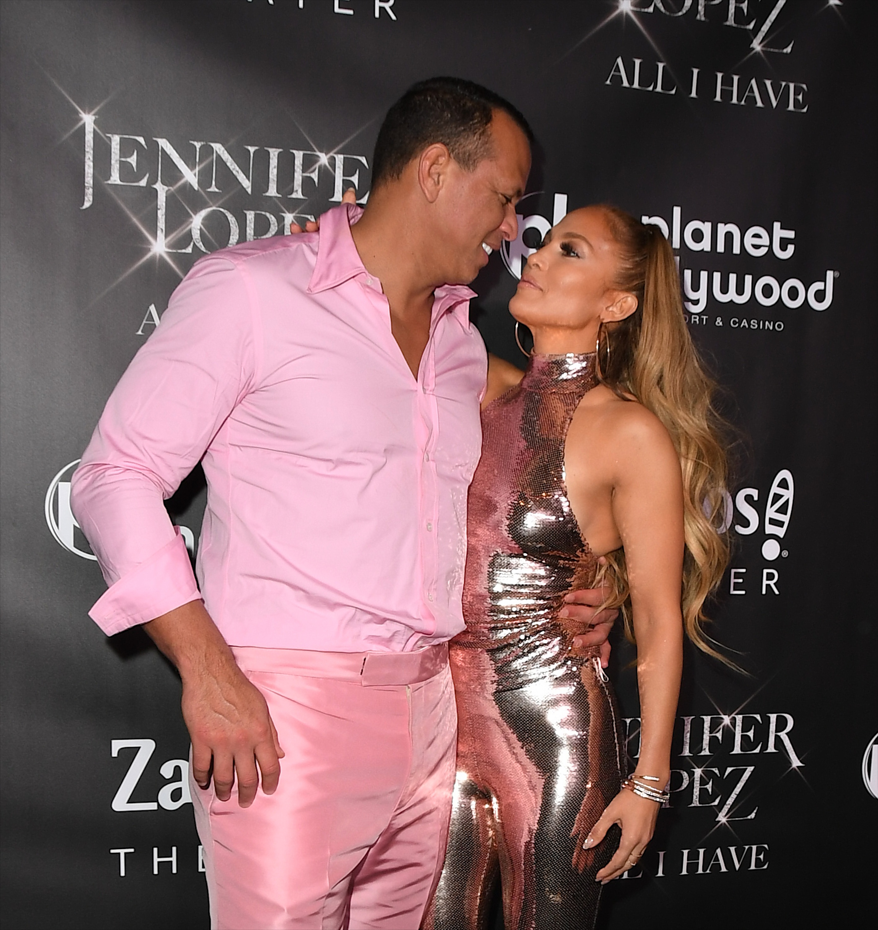 Jennifer Lopez Wears a Silver Sparkly Halter Jumpsuit and Stares Lovingly at Alex Rodriguez in a Pink Button Down Shirt With Pink Pants