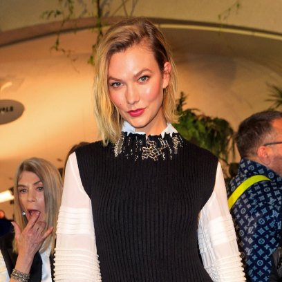Karlie Kloss Smiles With Short Blonde Hair White Blouse and Black Sweater Dress