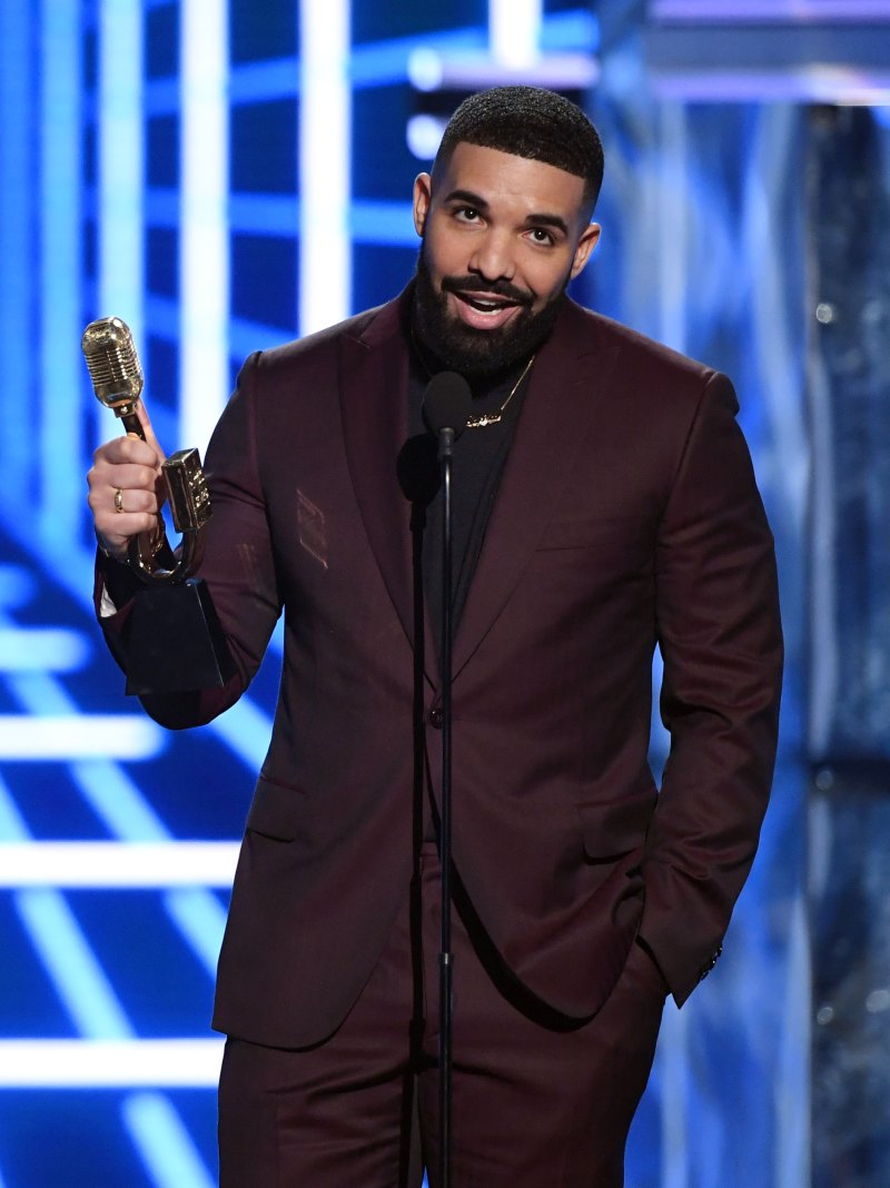 Drake Accepting an Award in a Maroon Suit With a Black Shirt