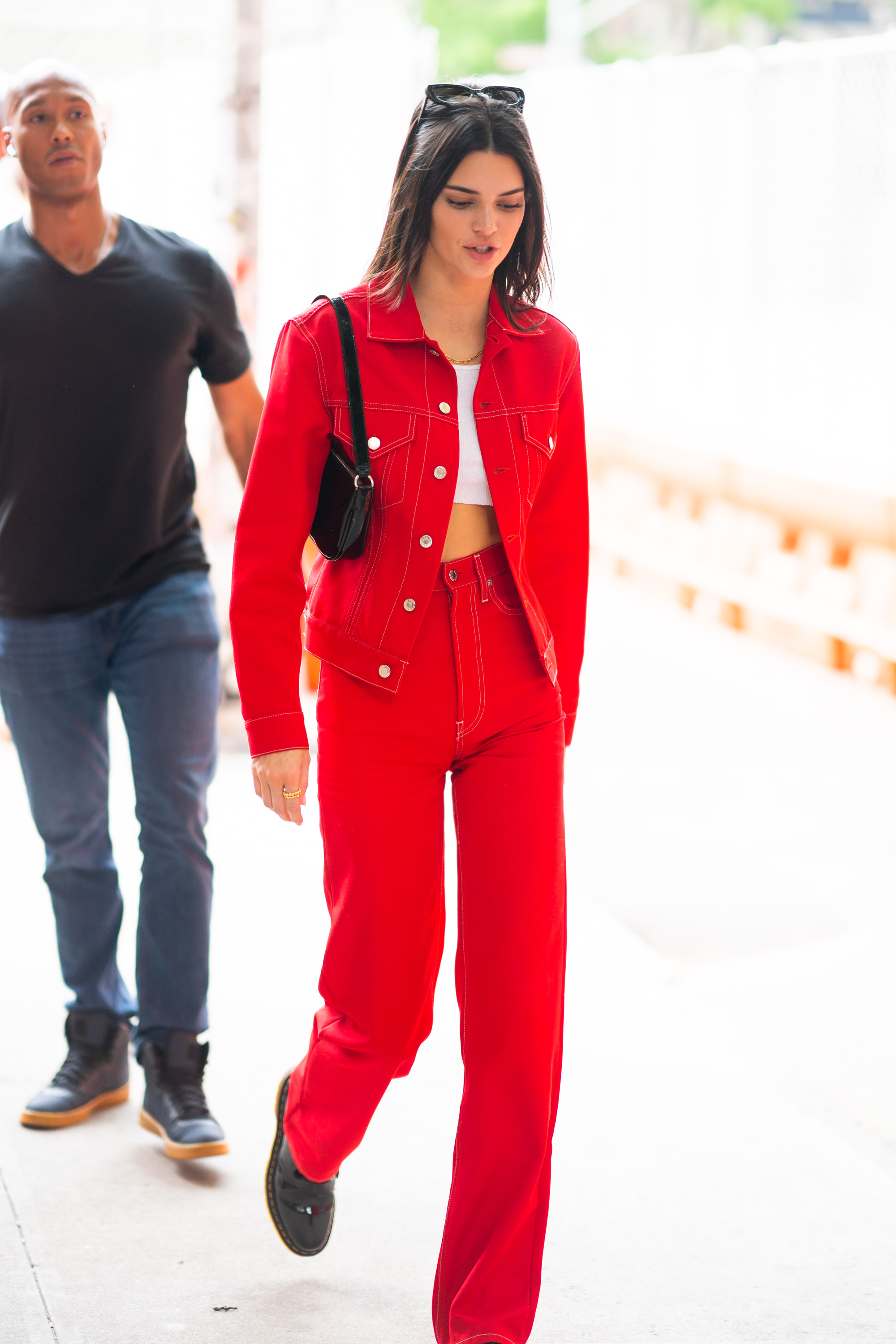 Kendall Jenner red jean jacket white crop top red jeans sunglasses black purse
