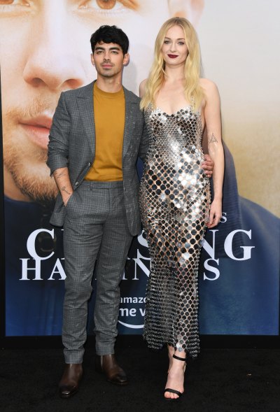 Sophie Turner Wears Mirrored Strapless Gown and Ruby Red Lip Standing With Joe Jonas in a Mustard Yellow Sweater and Grey Suit