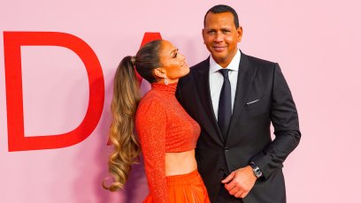 Jennifer Lopez Wears a Sparkly Orange Crop Top With Matching Orange Ball Gown Skirt and Long Curly Ponytail While Staring at Alex Rodriguez in a Black Suit and Black Tie at CFDA Awards
