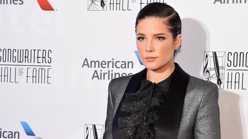 Halsey Holds Songwriters Hall of Fame Award in a Sparkly Silver Tux Jacket With a Black Blouse and Black Leather Leggings and Short Slicked Back Black Hair
