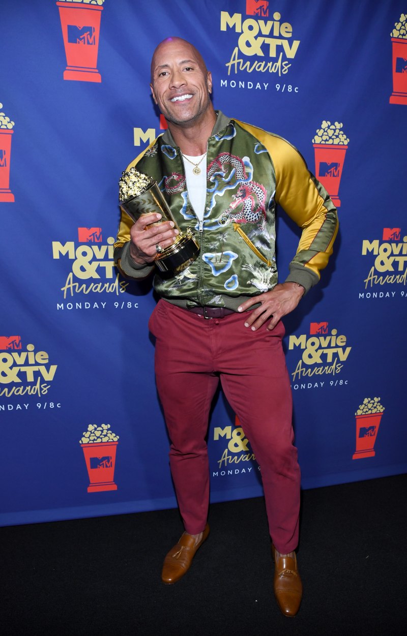 Dwayne the Rock Johnson smiles With MTV Award in Red Pants and a Patterned Jacket