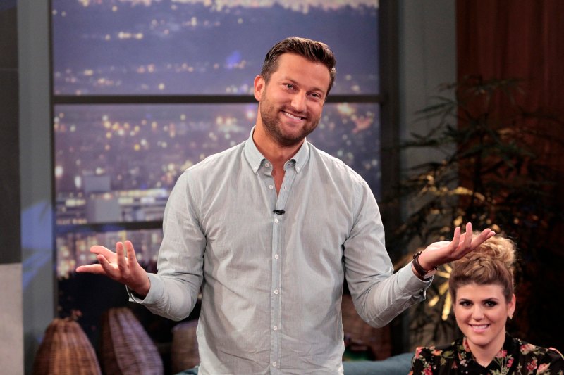 Bachelor Star Chris Bukowski Stands Shrugging on Television in Grey Button Down Shirt After Bachelor in Paradise