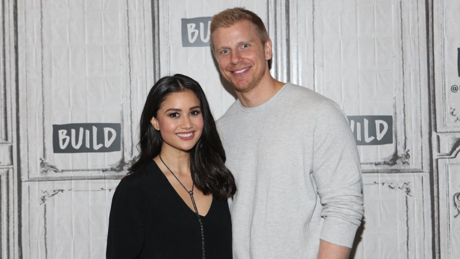 Catherine Lowe in a Black Top Stands With Husband Sean Lowe Wearing a White Sweater Pregnant With Baby No. 3