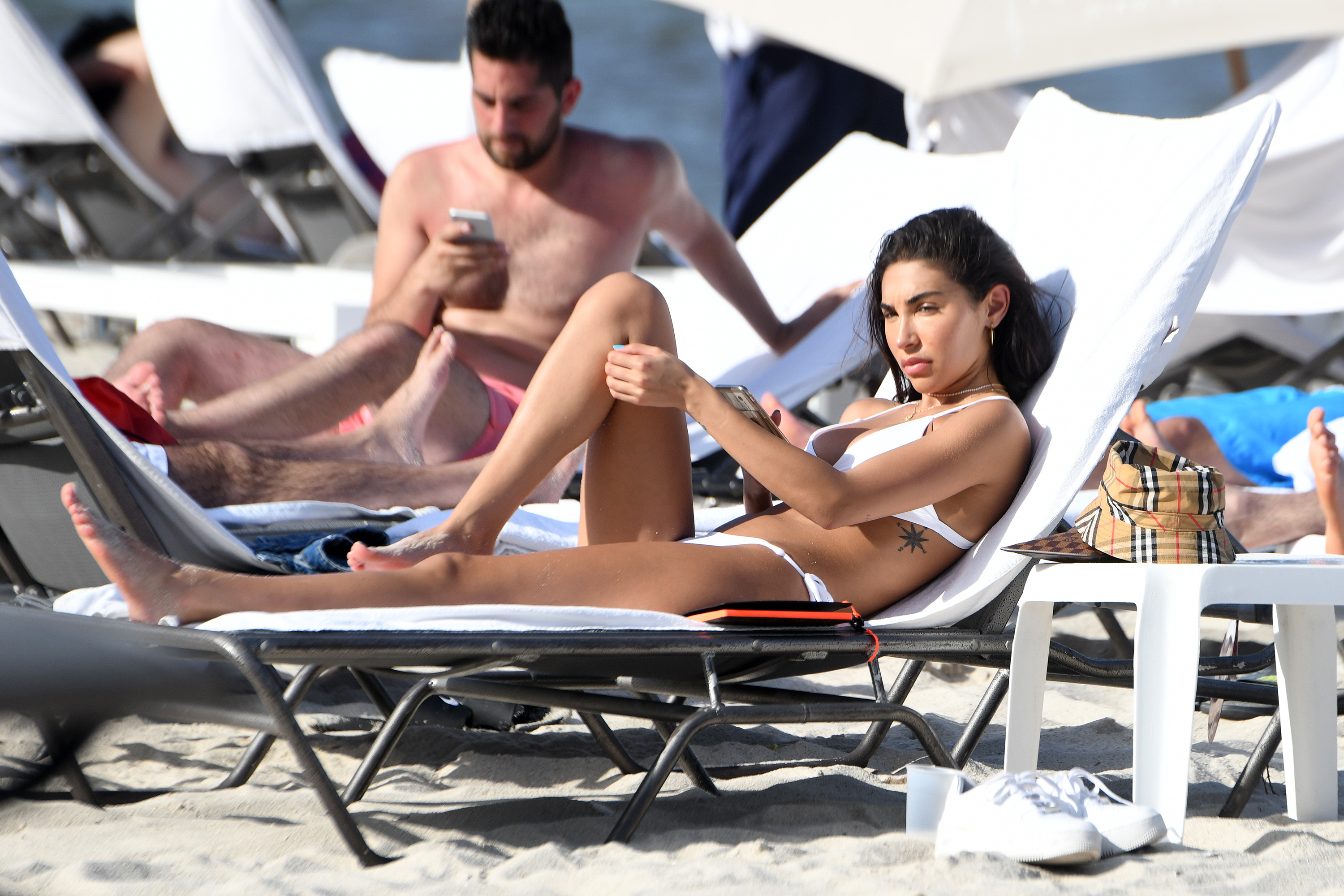 Chantel Jeffries Lounges in a White Bikini and Burberry Bucket Hat on Miami Beach