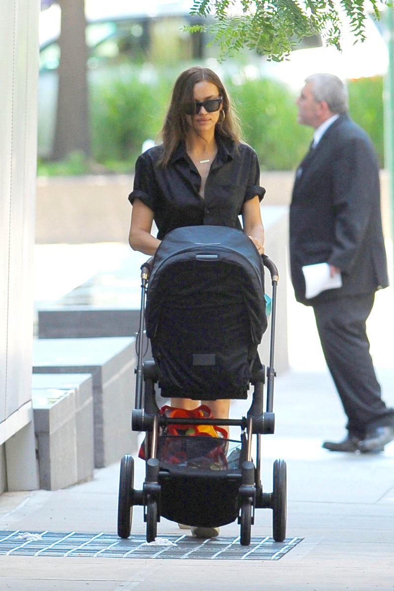Irina Shayk in a Black Top and Jean Shorts With a Black Stroller