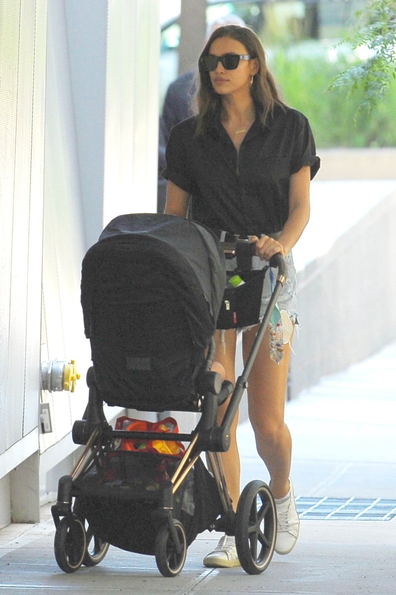 Irina Shayk in a Black Top and Jean Shorts With a Black Stroller