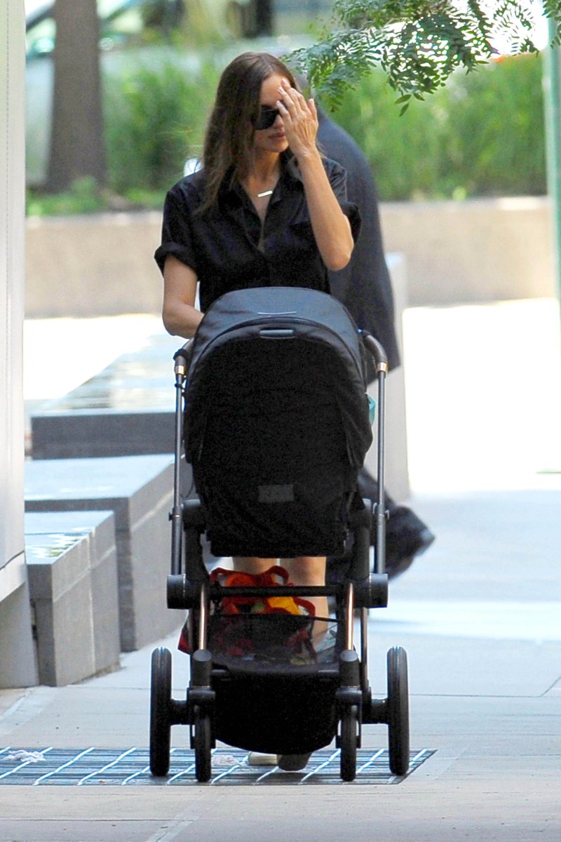 Irina Shayk in a Black Top and Jean Shorts With a Black Stroller