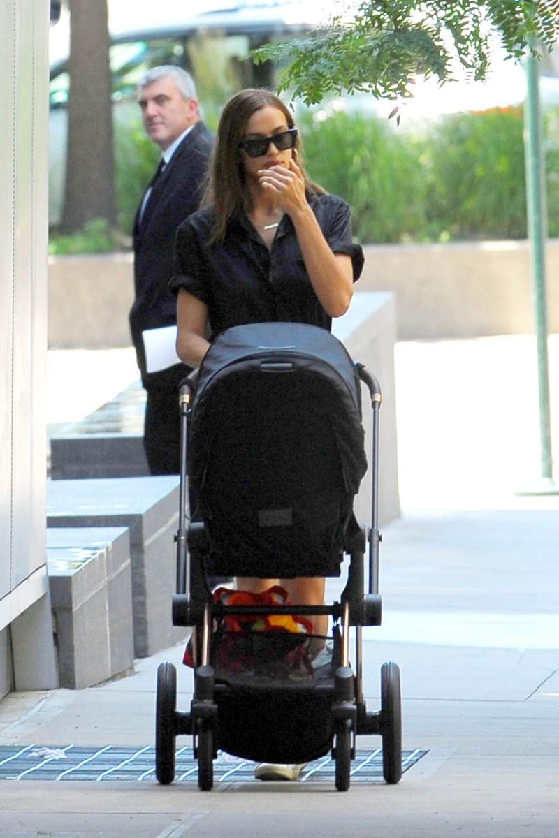 Irina Shayk in a Black Top and Jean Shorts With a Black Stroller
