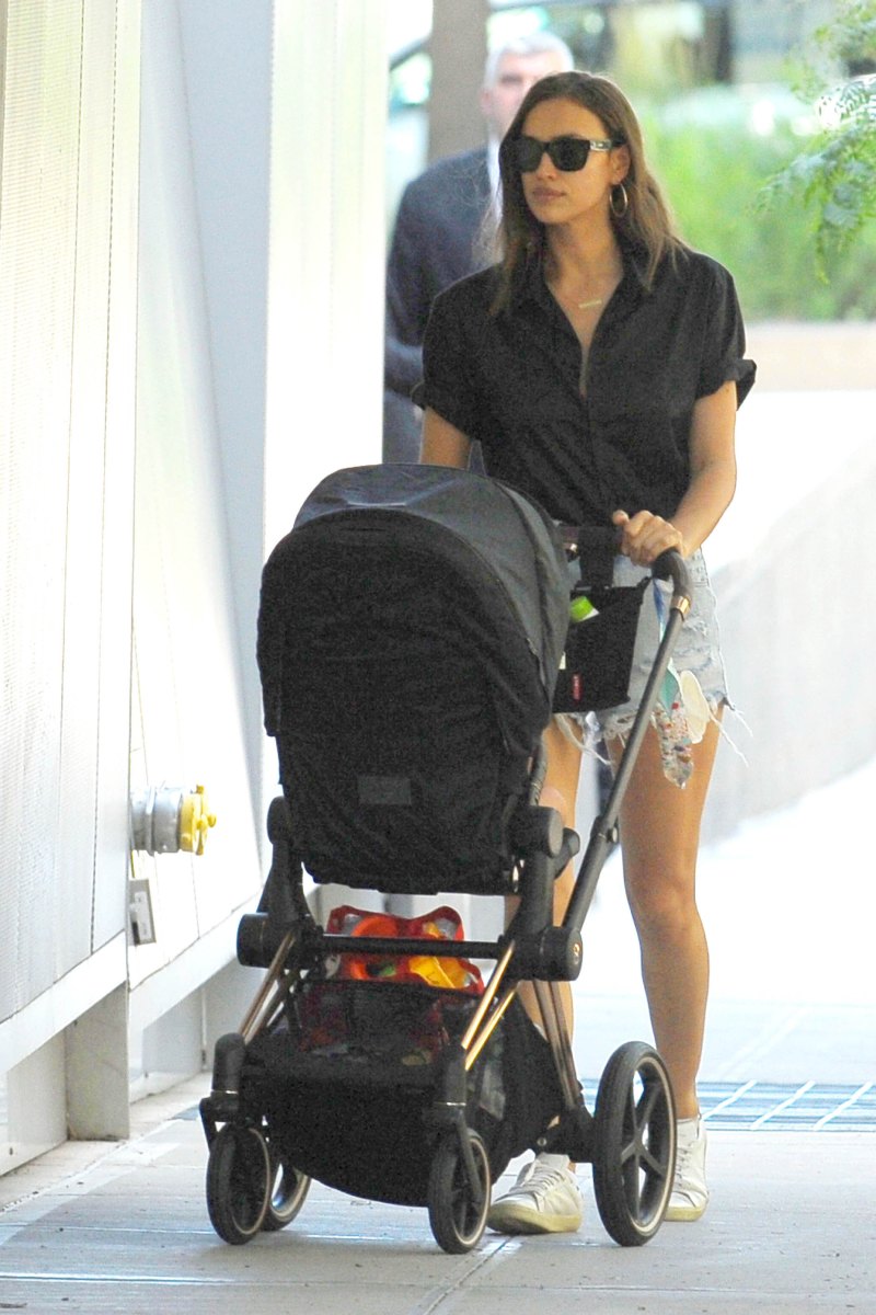 Irina Shayk in a Black Top and Jean Shorts With a Black Stroller