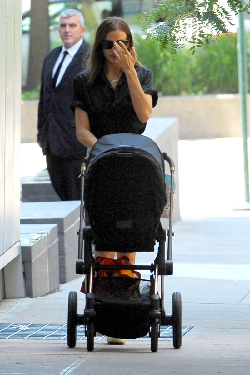 Irina Shayk in a Black Top and Jean Shorts With a Black Stroller